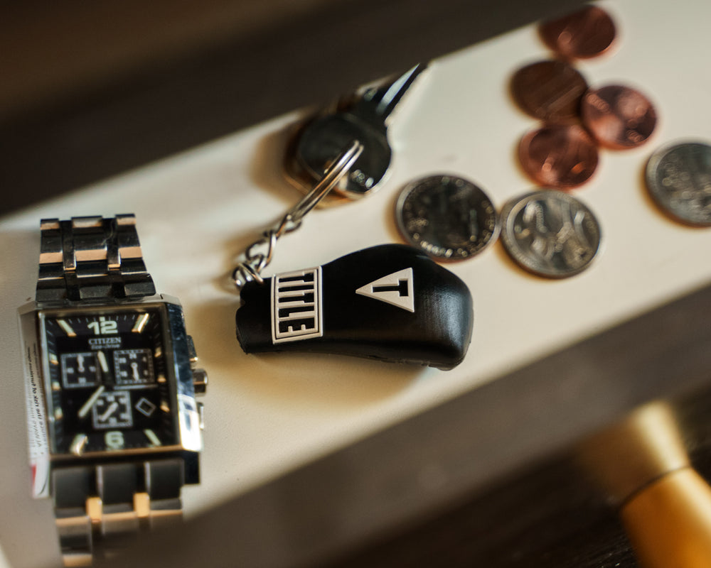 TITLE Boxing Molded Glove Keychain next to watch
