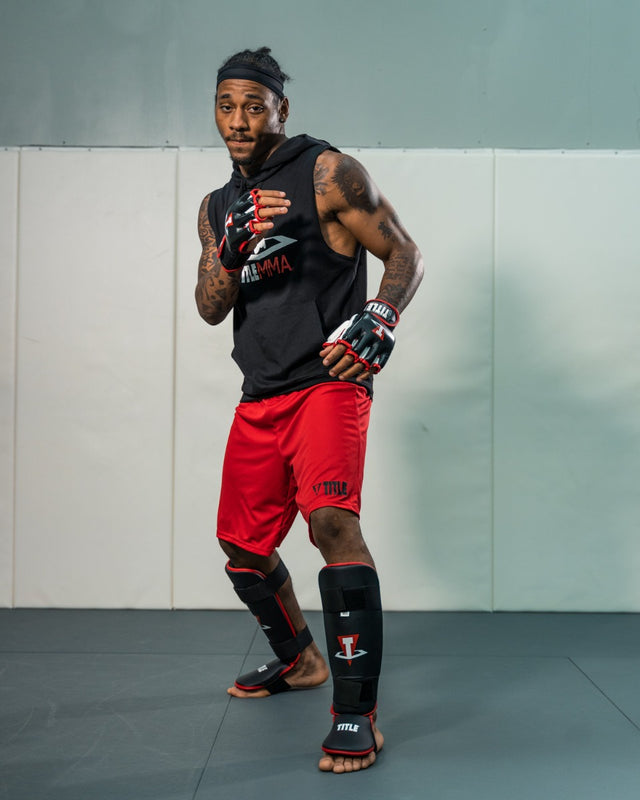 TITLE MMA Conflict Training Gloves man wearing gloves posing