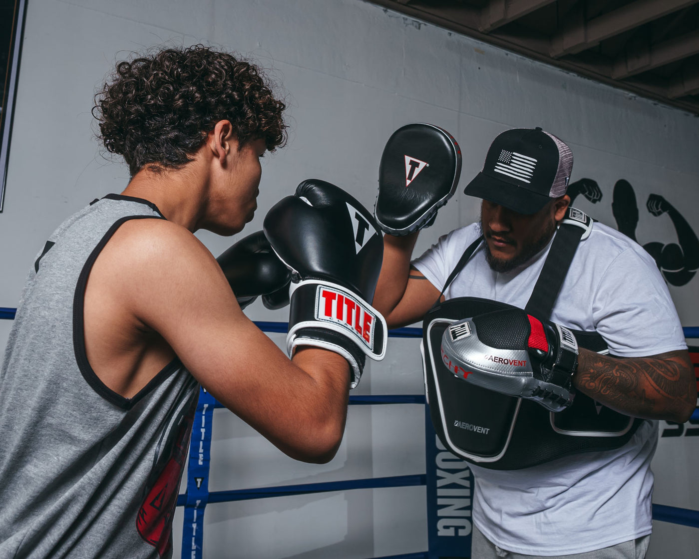 variant:lifestyle::TITLE Boxing Aerovent Anarchy Punch Mitts  kid mitting with coach