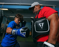variant:lifestyle::TITLE Boxing Aerovent Elite Body Protector boy hitting right jab