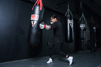 variant:White/Silver::Nike Fury Boots girl hitting a bag