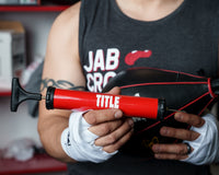 variant:lifestyle::TITLE Boxing Air Pump Rudy holding showing needle