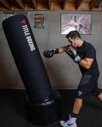 variant:black::TITLE Boxing AquaAir Freestanding Heavy Bag in action being punched by boxer