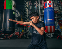 variant:lifestyle::TITLE Boxing Resistance Band Shadow Boxer child boxer using band