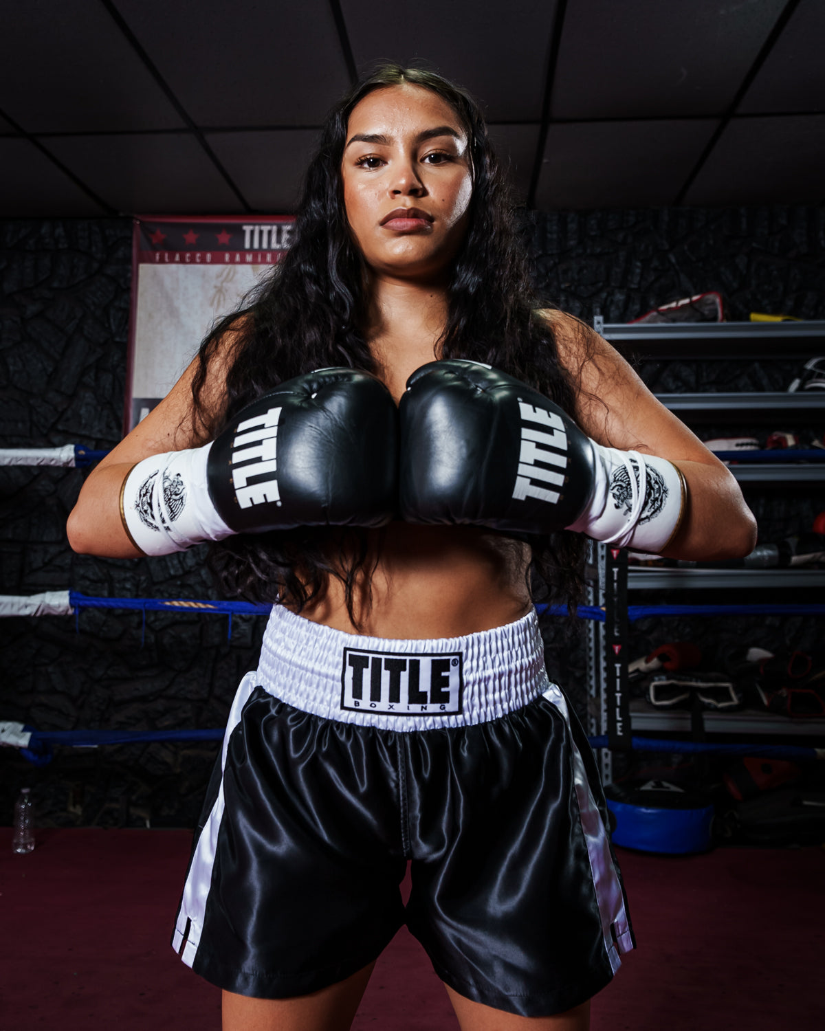 variant:Black/White/Gold::TITLE Boxeo Pro Fight Gloves girl in boxing stance