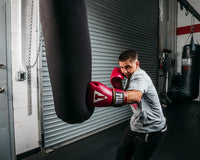 variant:red/white::TITLE Boxeo Mexican Leather Training Gloves Quatro guy hitting bag
