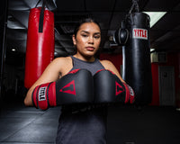 variant:Black/Red::TITLE Boxing Conquest Training Gloves on boxer in the gym