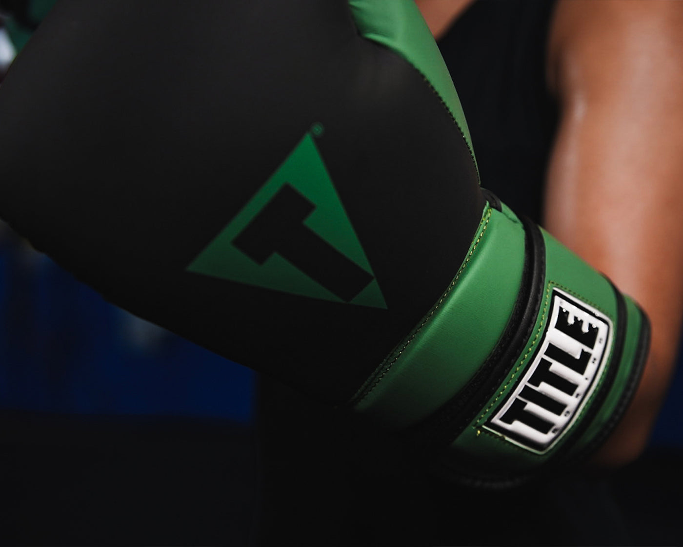 variant:Black/Green::TITLE Boxing Conquest Training Boxing Gloves closeup on glove on fighter's hand