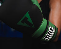 variant:Black/Green::TITLE Boxing Conquest Training Boxing Gloves closeup on glove on fighter's hand