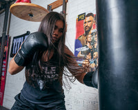 variant:lifestyle::TITLE Black Blitz Fit Boxing Gloves girl close up left jab