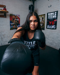 variant:lifestyle::TITLE Black Blitz Fit Boxing Gloves girl right jab
