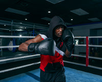 variant:lifestyle::TITLE Black Heavy Bag Gloves 2.0 left hand up boxing pose