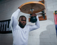 variant:lifestyle::TITLE Black Speed Bag 2.0 guy posing with bag/platform