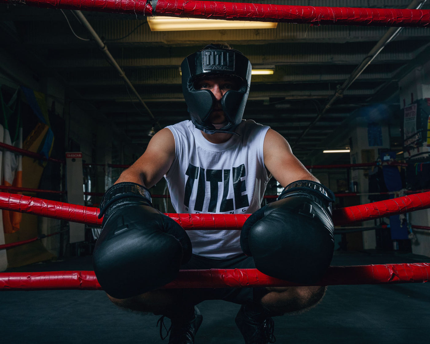 variant:lifestyle::TITLE Black Training Headgear guy on ring ropes