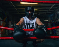 variant:lifestyle::TITLE Black Training Headgear guy on ring ropes