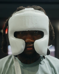 variant:white::TITLE Boxing Pro Sparring Headgear closeup on boxer's head front view