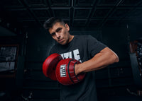 variant:lifestyle::TITLE Boxing Blood Red Leather Punch MItts put on stomach
