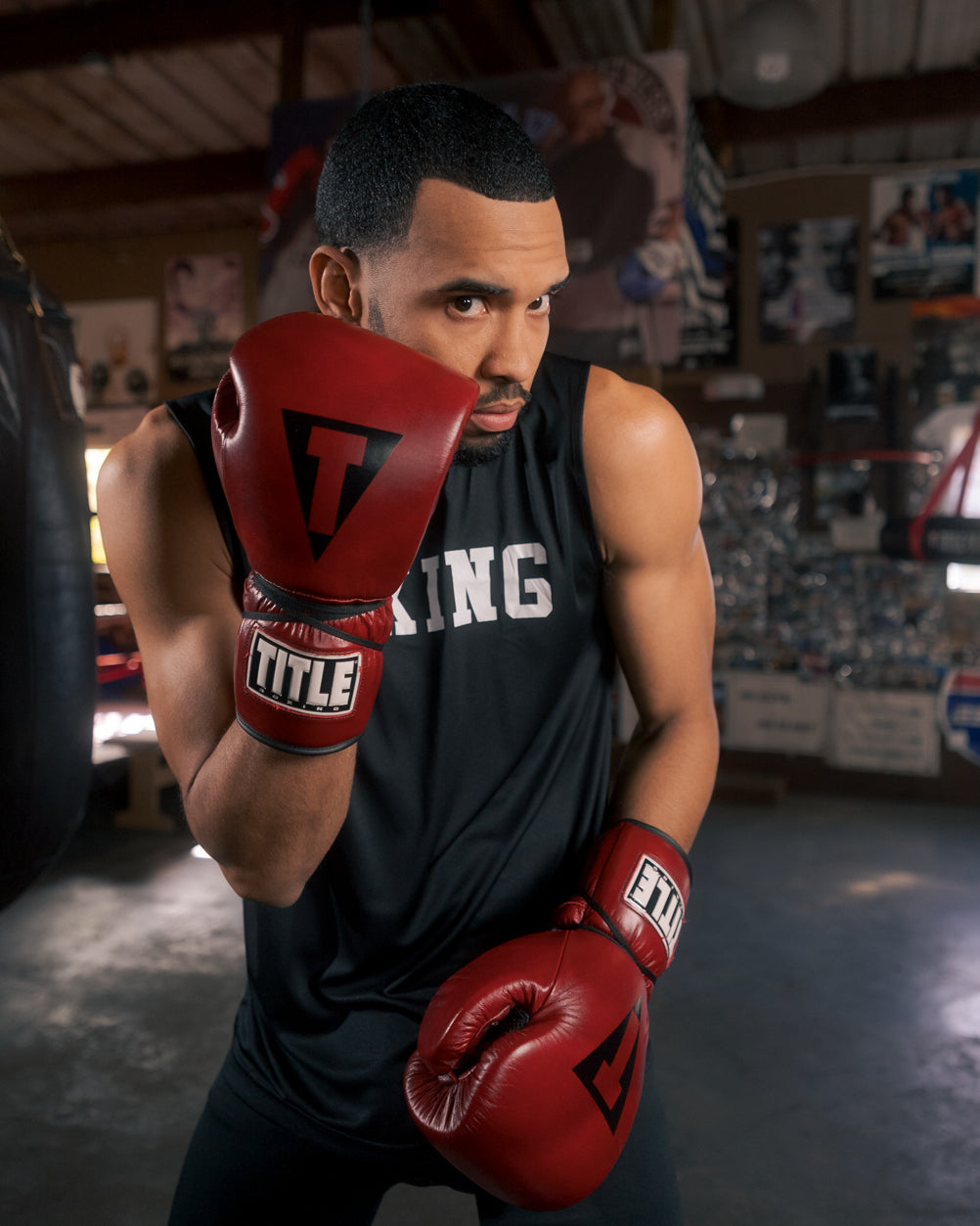 variant:lifestyle::TITLE Boxing Blood Red Headgear and Sparring Gloves Bundle on boxer in the gym