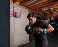 variant:black::TITLE Boxing Peak Bag Boxing Gloves in the gym second view