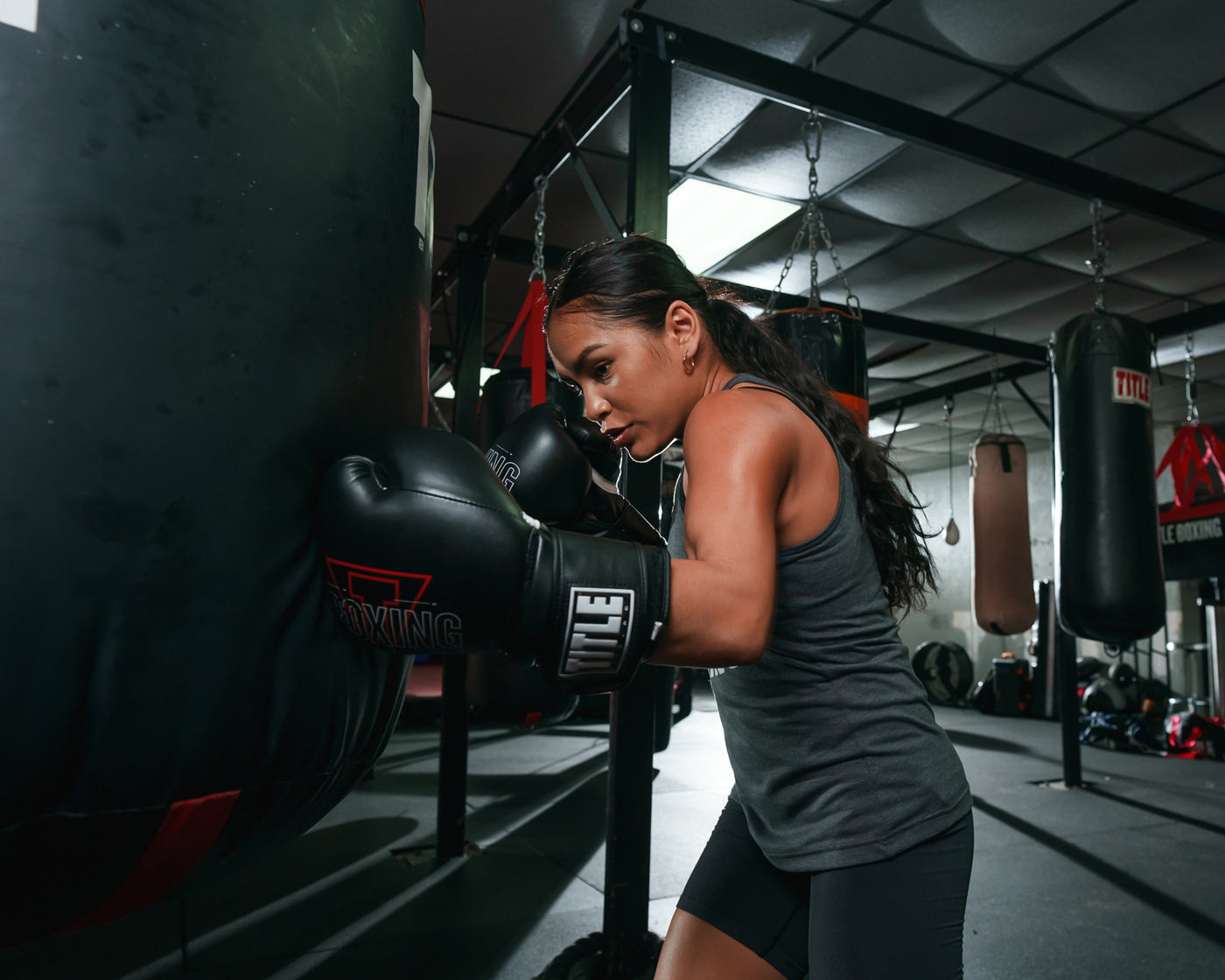 variant:black::TITLE Boxing Peak Training Boxing Gloves in the gym