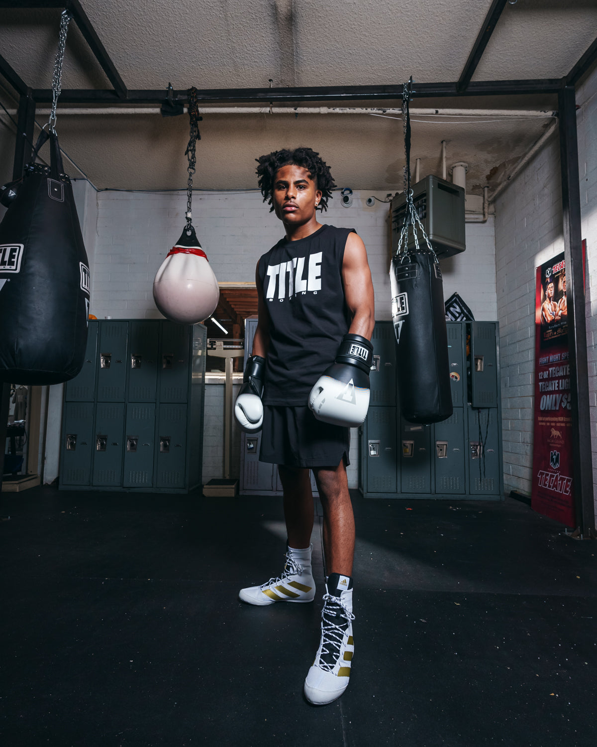 variant:black/white::TITLE Boxing Rush training gloves boxer standing bags in background