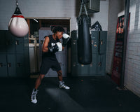 variant:black/white::TITLE Boxing Rush training gloves boxer boxing stance with bag