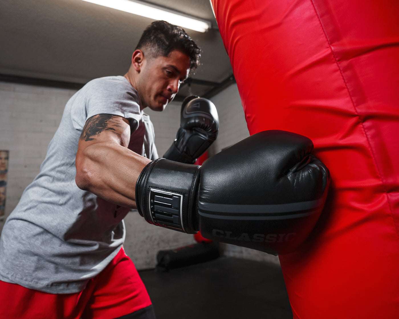 variant:black/grey::TITLE Classic Speed Boxing Gloves guy hitting bag