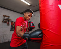 variant:black/red::TITLE Classic Speed Boxing Gloves guy hitting bag