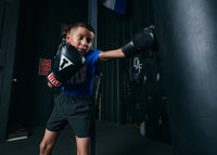 variant:lifestyle::TITLE Classic Boxing Gloves boy hitting bag left jab