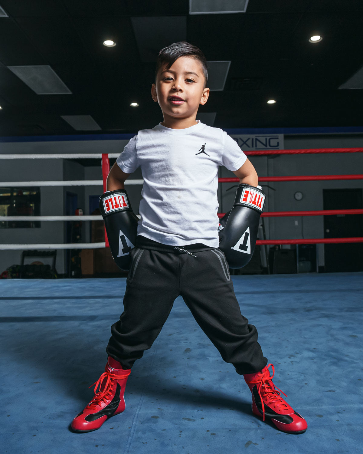 variant:lifestyle::TITLE Classic Black Max Boxing Gloves kid hands on hips