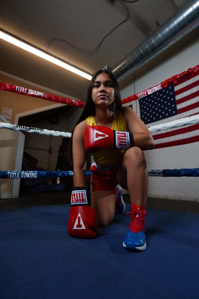 variant:red::TITLE Classic USA Boxing Competition Gloves girl kneeling on ring