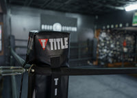 variant:black::TITLE Boxing Blank Pro Corner Cushion V3.0 on the corner of ring