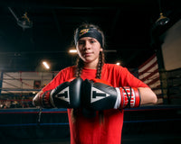 variant:Black/Red::TITLE Classic Pro Fight Gloves girl touching gloves together
