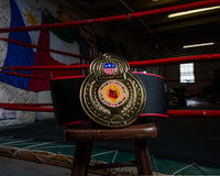 variant:lifestyle::TITLE Boxing Old School Title Belt belt on stool