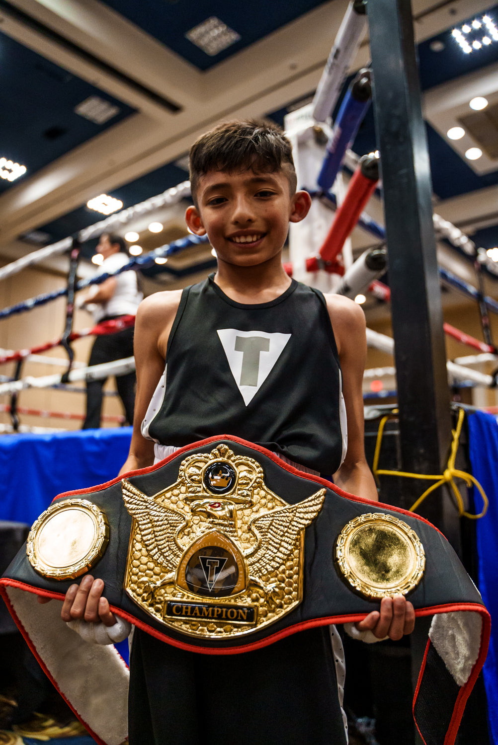 variant:black::TITLE Boxing Truimphant Wings of Victory Belt kid holding belt