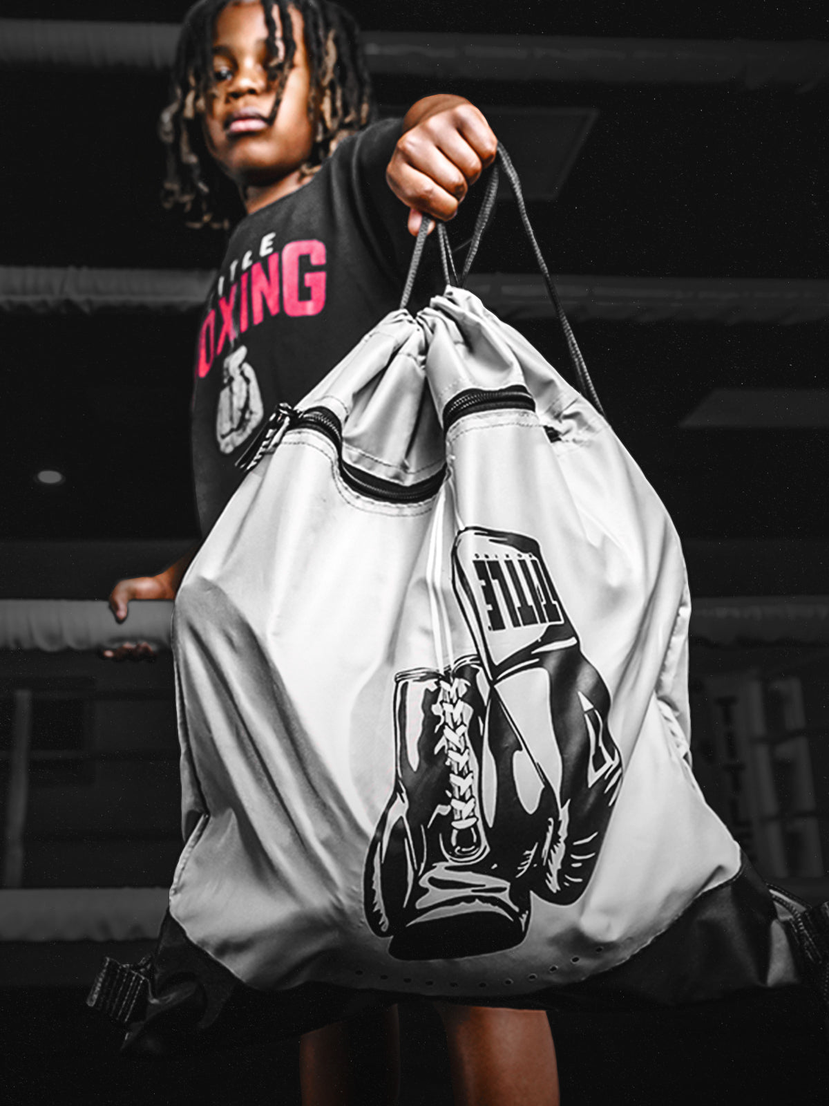 youth boxer holding a bag