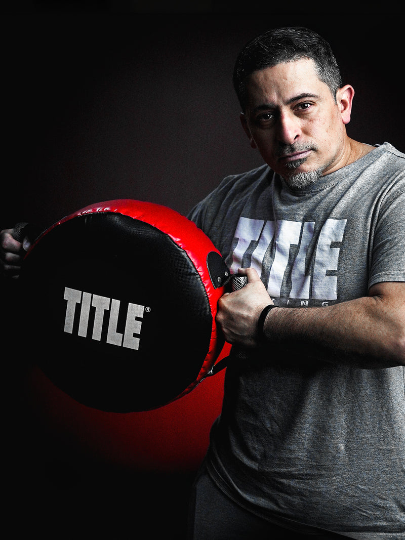 punch shield in use by boxing coach