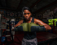 variant:Green/Black::TITLE Boxing Combat Bag Gloves 2.0 Girl with knuckles touching