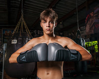 variant:Grey/Black::TITLE Boxing Combat Bag Gloves 2.0 Boy with knuckles touching
