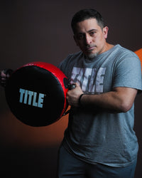 variant:lifestyle::TITLE Classic Round Punch Shield V2 being held up