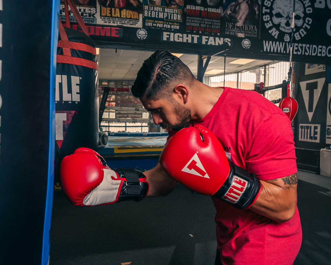 variant:lifestyle::TITLE Classic Power Weight Bag Gloves guy punching a bag