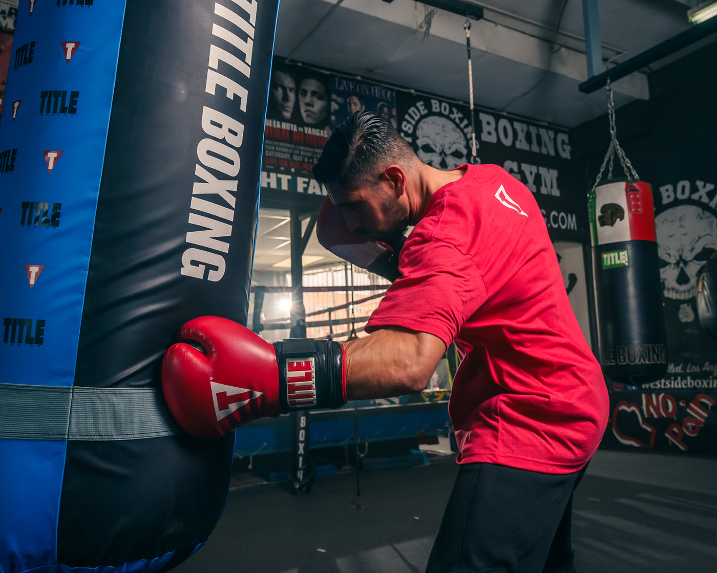 variant:lifestyle::TITLE Classic Power Weight Bag Gloves guy punching a bag