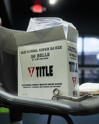 variant:lifestyle::TITLE Boxing Trainers Scissors resting on a box of boxing gauze