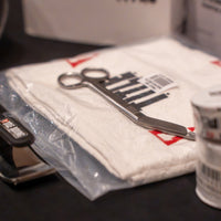 variant:lifestyle::TITLE Boxing Trainers Scissors on top of towel