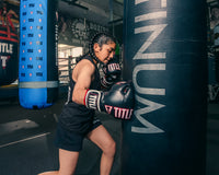 variant:Black/Red::TITLE Boxing Gel Soft Strike Bag Gloves girl hitting bag