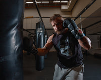 variant:black::TITLE Classic Leather Lace Training Gloves 2.0 guy hitting bag