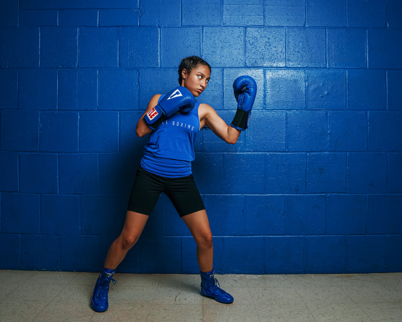 variant:blue::TITLE Classic Leather Elastic Training Gloves guy holding gloves together