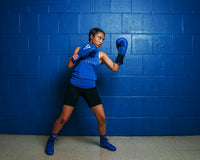 variant:blue::TITLE Classic Leather Elastic Training Gloves guy holding gloves together