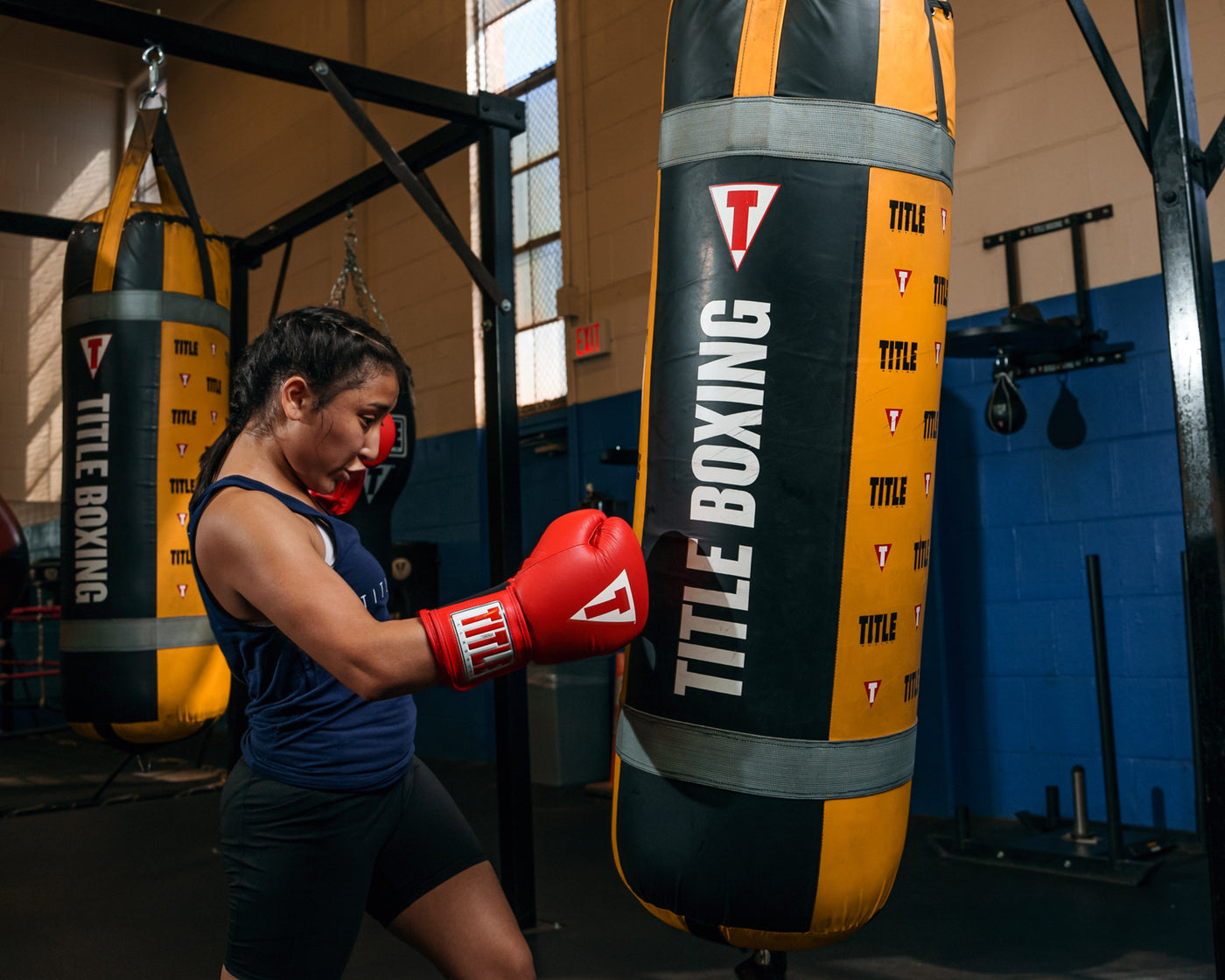 variant:red::TITLE Classic Leather Elastic Training Gloves guy holding gloves together