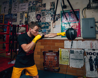 variant:9"::TITLE Boxing Double End Bag kid hitting double end bag with hand wraps